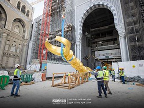 Installation of the last crescent underway at the Grand Mosque in Mecca.