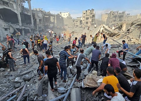 Palestinians search for casualties at the site of Israeli strikes on houses in Jabaliya refugee camp in the northern Gaza Strip, October 31, 2023.