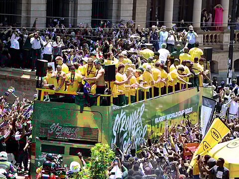 South Africa players and staff celebrate winning the World Cup on the bus during the trophy tour at Church Square, Pretoria, South Africa on Thursday.