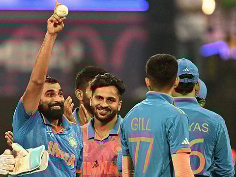 India's Mohammed Shami (left) celebrates with teammates after taking five wickets against Sri Lanka in Mumbai on Thursday.