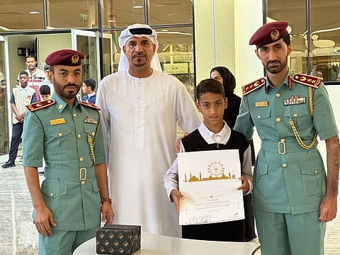 10-year-old Emirati student Ahmed Haitham Al Naqbi being honoured by Sharjah Civil Defence officials.