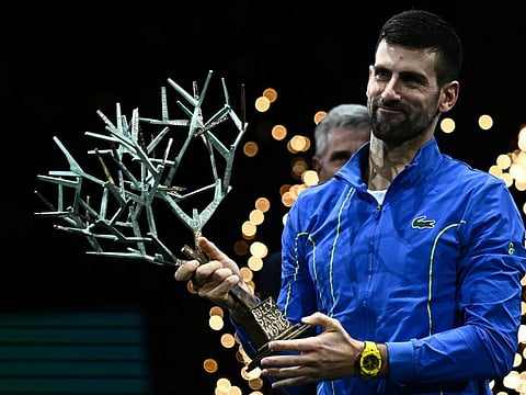 Serbia's Novak Djokovic celebrates with the trophy after winning the men's singles final match of the Paris ATP Masters 1000 tournament against Bulgaria's Grigor Dimitrov at the Accor Arena - Palais Omnisports de Paris-Bercy - in Paris on Sunday.