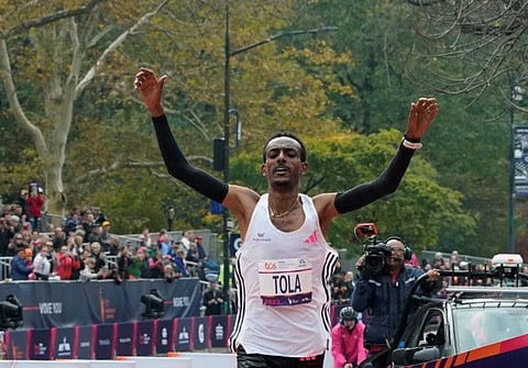 Ethiopia's Tamirat Tola celebrates winning the 52nd Edition of the New York City Marathon on Sunday.