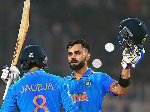 India’s Virat Kohli raises his bat after completing a century against South Africa in the ICC Men’s Cricket World Cup 2023 at Eden Gardens in Kolkata, India, on November 5, 2023. With his 49th ODI century, he equalled Sachin Tendulkar’s record. The unbeaten 101 was Kohli’s second century of the tournament.