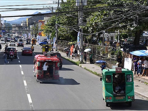 Vehicles and pedestrians along Justice Romualdez street in Tacloban city, Leyte province.