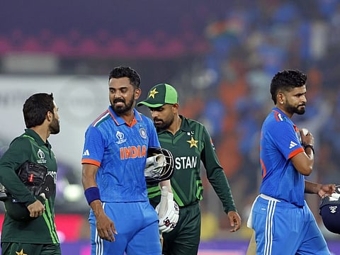India and Pakistan players leave the field after the league match in Ahmedabad on October 14. The Asian giants could meet again in the semifinals.