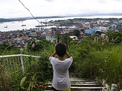 A young boy looks over the city center of Tacloban, Leyte province.