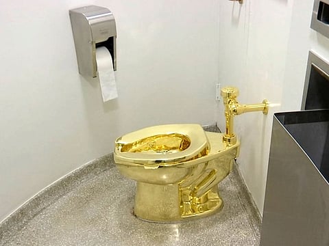 This Sept. 16, 2016 file image made from a video shows the 18-karat toilet, titled "America," by Maurizio Cattelan in the restroom of the Solomon R. Guggenheim Museum in New York.