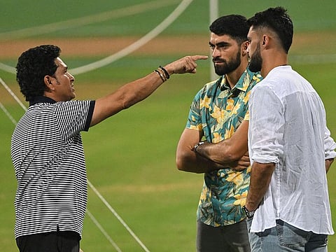 Indian legend and ICC Global Ambassador Sachin Tendulkar (left) speaks with Afghanistan's Ibrahim Zadran (centre) and Naveen-ul-Haq on the eve of their match against Australia in Mumbai.