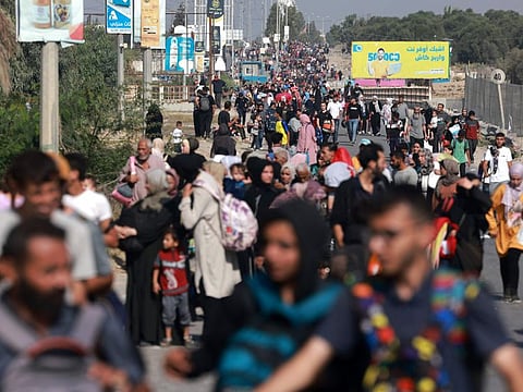Palestinians fleeing Gaza City and other parts of northern Gaza towards the southern areas, walk on a road on November 8, 2023 amid the ongoing battles between Israel and the Palestinian Islamist group Hamas.