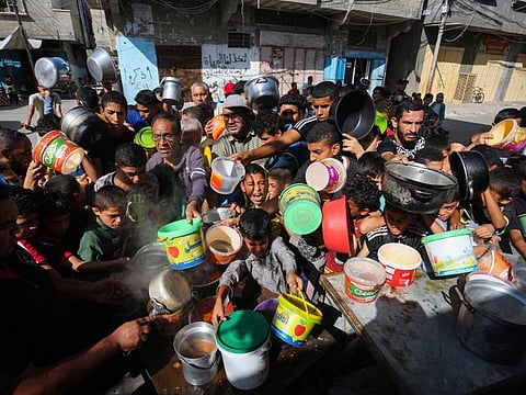 Palestinians crowded together as they wait for food distribution in Rafah, southern Gaza Strip, on November 8, 2023. Since the start of the Israel-Hamas war, Israel has limited the amount of food and water allowed to enter the territory, causing widespread hunger across the strip (AP Photo/Hatem Ali)