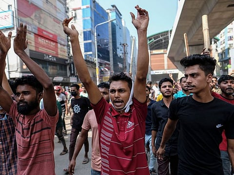 Bangladeshi garment workers shout slogans during a protest demanding an increase in their wages at Mirpur in Dhaka, Bangladesh, Tuesday, Oct.31