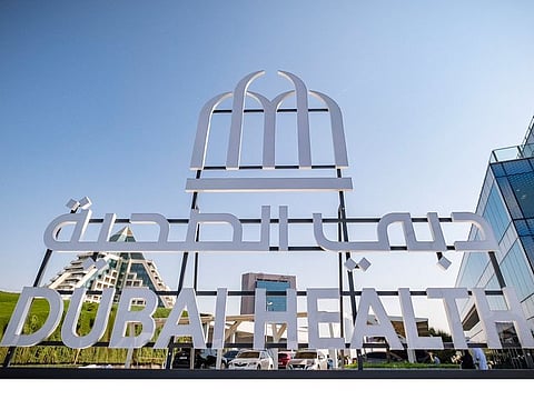 The logo features three arches anchored by a foundation