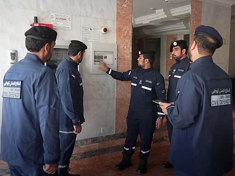 Still from Abu Dhabi Civil Defence video shared by Abu Dhabi Media Office, showing officials checking fire systems in a building