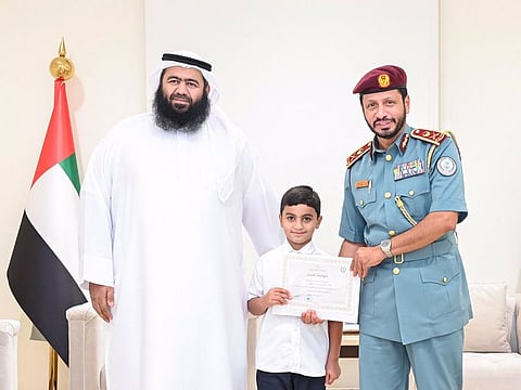Ali Mohammed bin Harib Al Muhairi (centre) with his father (left) and Major General Saif Al Zari Al Shamsi, Commander-in-Chief of Sharjah Police