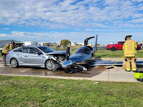 This photo provided by the McKinney Fire Department shows officials at the site of a crash involving a small plane and a vehicle near Aero Country Airport, Saturday, Nov. 11, 2023, in McKinney, Texas.