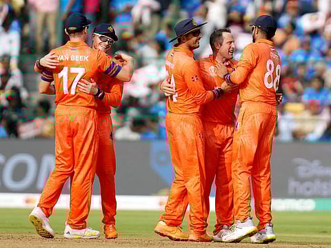 Netherlands’ Roelof van der Merwe celebrates the wicket of India’s Virat Kohli during the ICC Men's Cricket World Cup match at the M. Chinnaswamy Stadium in Bengaluru on November 12, 2023. The Dutch lost the match and exited the tournament with two wins and seven losses.
