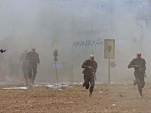 Lebanese Hezbollah militants take part in cross-border raids, part of large-scale military exercise, in Aaramta bordering Israel on May 21, 2023 ahead of the anniversary of Israel's withdrawal from southern Lebanon in 2000.