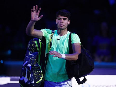 Spain's Carlos Alcaraz waves after losing his group stage match to Germany's Alexander Zverev at the ATP Finals in Turin.