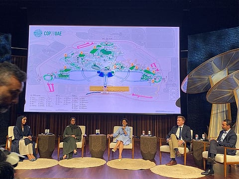 Top Expo City Dubai executives address a press conference on Tuesday. Seen above them is a map showing the green and blue zones.