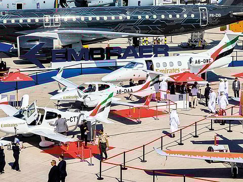 Emirates Flight Training Academy Cirrus Aircraft SR22 and Diamond DA42 propeller planes along with an Embraer Phenom 100 are displayed on the tarmac during the Dubai Airshow 2023 at Dubai World Central.