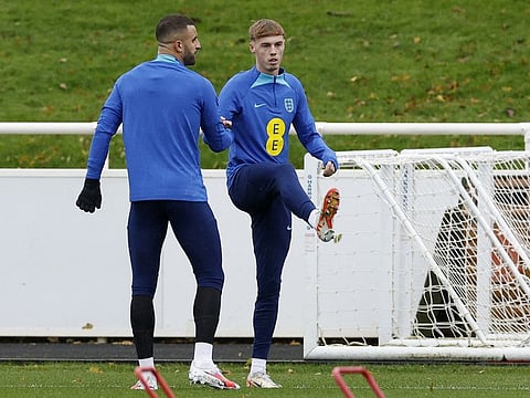England's Cole Palmer with Kyle Walker during training for the Euro 2024 Qualifier at St George's Park, Britain on Tuesday.