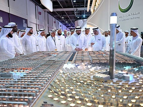 Sheikh Ahmed bin Mohammed bin Rashid Al Maktoum, Second Deputy Ruler of Dubai, and DEWA CEO Saeed Mohammed Al Tayer at the DEWA pavilion at the event, showing a model of Mohammed bin Rashid Al Maktoum Solar Park, the world’s largest single-site solar park in Dubai, on Wednesday