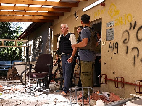 European Union Foreign Policy Chief Josep Borrell (centre) walks past debris during his visit to Kibbutz Beeri near the border with the Palestinian Gaza Strip on November 16, 2023.