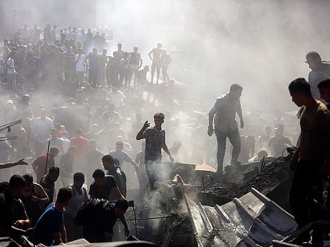 Palestinians inspect the rubble of destroyed buildings following Israeli airstrikes on the town of Khan Younis, southern Gaza Strip last week