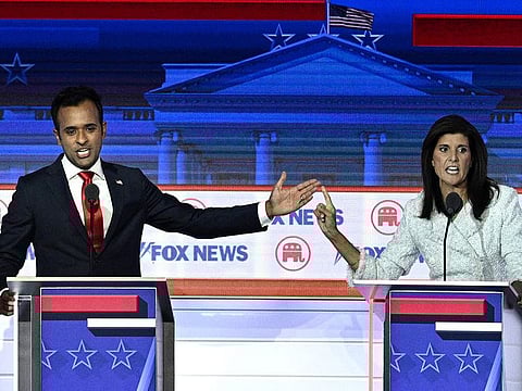 Entrepreneur and author Vivek Ramaswamy and former Governor from South Carolina and UN ambassador Nikki Haley gesture as they speak during a Republican Presidential primary debate