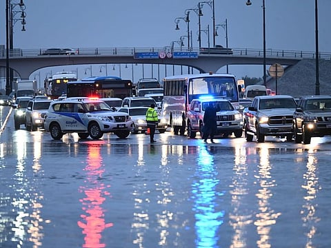 Sharjah Police patrols help redirect traffic in the emirate following a heavy downpour on Friday.