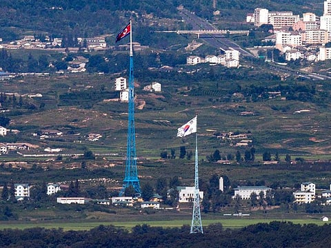 Flags of North Korea, rear, and South Korea, front from the border area between two Koreas in Paju, South Korea.