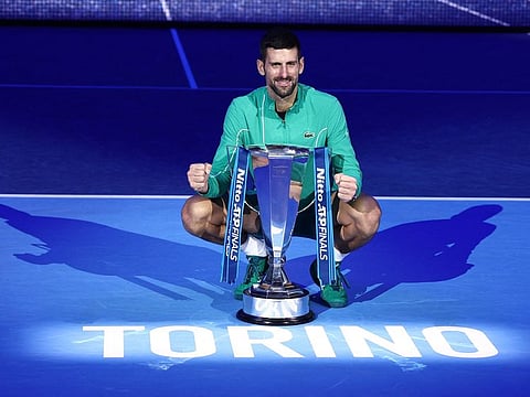 Serbia's Novak Djokovic celebrates with a trophy after winning the final against Italy's Jannik Sinner in Turin, Italy, on Sunday.