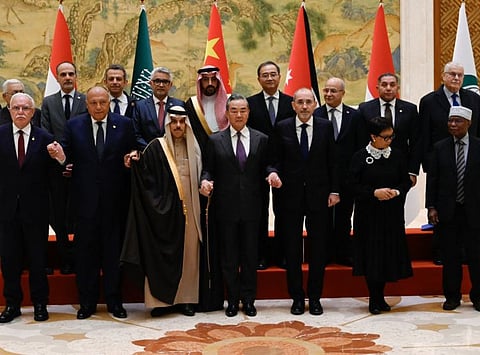 China's Foreign Minister Wang Yi (front row 4rth right) poses for a group photo with Saudi Arabia's Foreign Minister Prince Faisal bin Farhan Al Saud (front row 3rd left), Jordan's Deputy Prime Minister and Foreign Minister Ayman Safadi (front row 3rd right), Egypt's Foreign Minister Sameh Shoukry (front row 2nd left), Indonesia's Foreign Minister Retno Marsudi (front row 2nd right), Palestinian Foreign Minister Riyad Al Maliki (front row left), and Organisation of Islamic Cooperation (OIC) Secretary-General Hissain Brahim Taha (front row right) before a meeting of foreign ministers from Arab and Muslim-majority nations at the Diaoyutai State Guest House in Beijing on November 20, 2023.