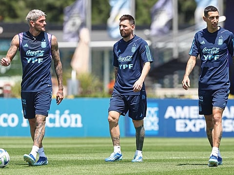 From left: Argentina's midfielder Rodrigo De Paul, forwards Lionel Messi, and Angel Di Maria walk during a training session in Ezeiza, Buenos Aires Province, on Monday.