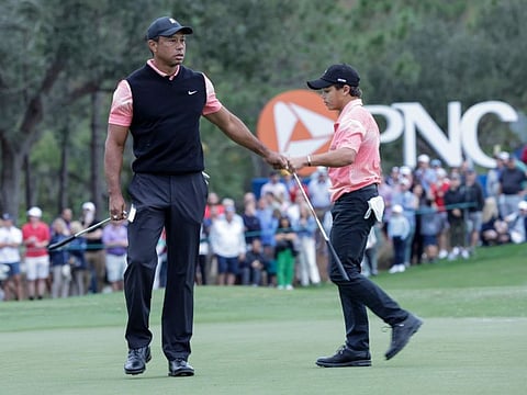 Tiger Woods congratulates his son Charlie Woods after finishing the 18th hole during the first round of the PNC Championship tournament in 2022.