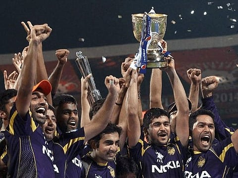 Kolkata Knight Riders skipper Gautam Gambhir holds the IPL trophy along with his teammates.