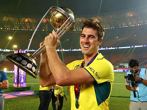 Australia's Pat Cummins celebrates with the trophy after winning the World Cup in Ahmedabad on Sunday.