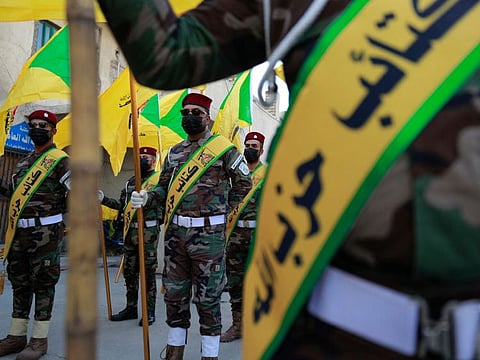 Members of the Hezbollah brigades, Kataeb Hezbollah, attend the funeral of Fadel Al Maksusi, a militant who was also part of the Islamic resistance in Iraq, the group that has claimed all recent attacks against US troops in Iraq and Syria, in Baghdad on November 21, 2023.