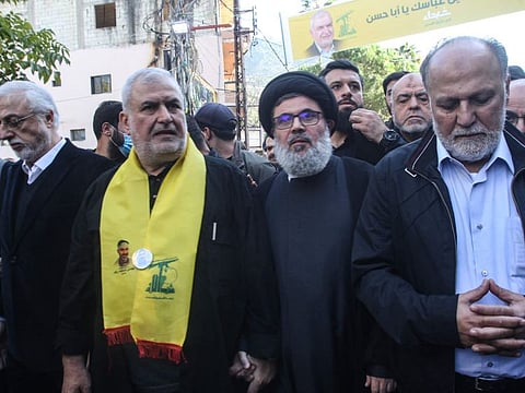 Head of the Hezbollah parliament Mohammad Raad (second left) flanked by senior Hezbollah officials Hashem Safi Al Deen (2nd right) and Ali Ammar (right) and Lebanese MP Jihad Al Samd, takes part in the funeral of his son Abbas Raad, killed in southern Lebanon in cross-border fire with Israeli troops, in Jbaa in southern Lebanon on November 23, 2023.