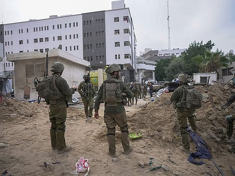 Israeli soldiers stand outside Al Shifa Hospital in Gaza City, Wednesday, Nov. 22, 2023.
