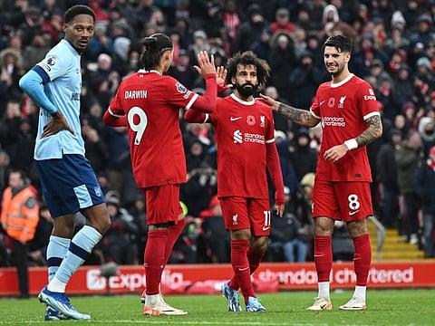 Liverpool's Mohamed Salah (centre) is congratulated after scoring their second goal during the English Premier League match against Brentford at Anfield.