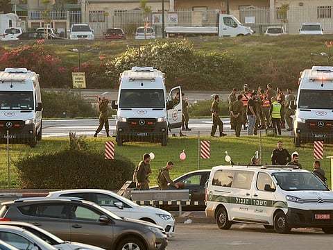 Israeli security forces stand next to ambulances waiting outside the helipad of Tel Aviv's Schneider medical centre on November 24, 2023, amid preparations for the release of Israeli hostages held by Hamas in Gaza in exchange for Palestinian prisoners later in the day.
