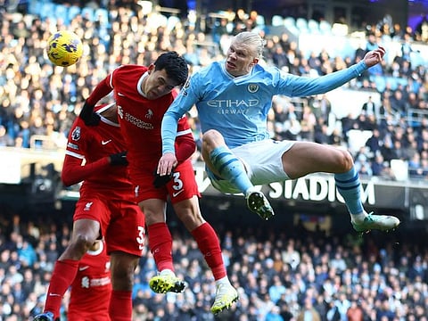 Manchester City's Erling Braut Haaland battles with Liverpool's Wataru Endo during a Premier League match at Etihad Stadium, Manchester on Saturday.