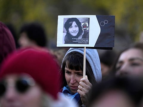 A woman shows a photo of Giulia Cecchettin, allegedly killed by ex-boyfriend, on the occasion of International Day for the Elimination of Violence against Women, in Milan, Italy, Saturday, Nov.25, 2023.