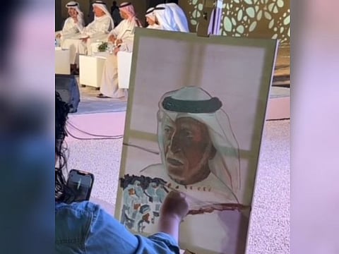 Still from a video of artist Malak Al Ajou painting a portrait of a poet as part of the Al Ain Book Festival events at Al Jahili Fort in Al Ain