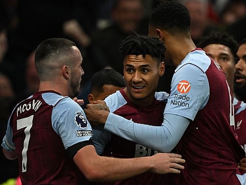 Aston Villa's Ollie Watkins celebrates scoring their second goal with John McGinn and Ezri Konsa during a Premier League match against Tottenham Hotspur on Sunday.