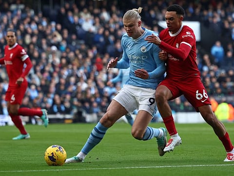 Liverpool's English defender Trent Alexander-Arnold (right) vies with Manchester City's Norwegian striker Erling Haaland during a Premier League match.