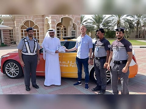 A motorist (second from left) with the Happiness Patrol at his home in Al Ain