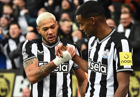 Newcastle United's striker Joelinton (left) celebrates scoring a goal with striker Alexander Isak during the Premier League match against Chelsea at St James' Park in Newcastle-upon-Tyne on November 25.